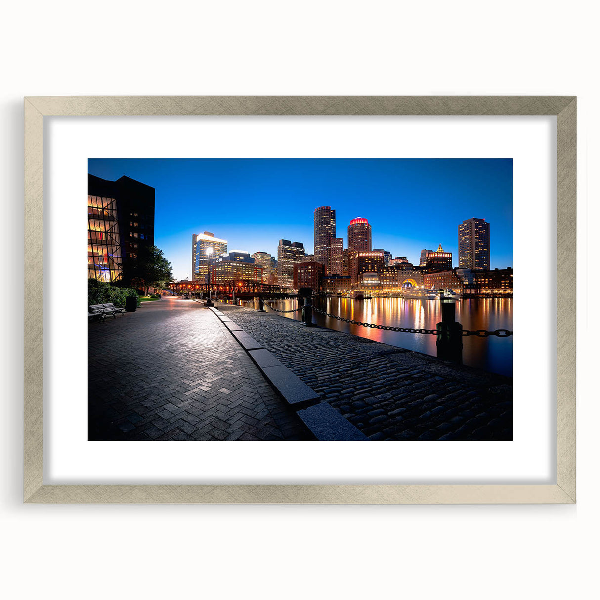 Textured art print of abstract Boston skyline in muted blue and gray tones, framed in silver, suitable for bedroom decor.