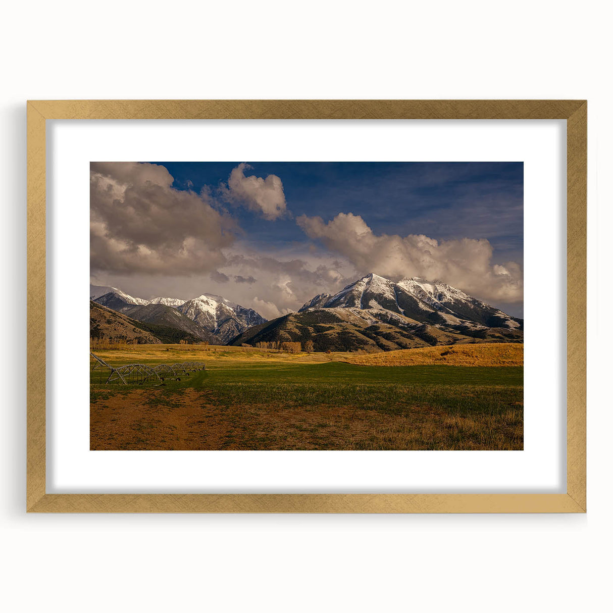 Extra large abstract art print depicting a textured Montana scenery in muted earth tones, framed in gold.