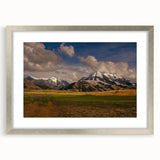 Textured abstract art print of Montana scenery in muted earth tones, framed in silver, ideal for bedroom decor.
