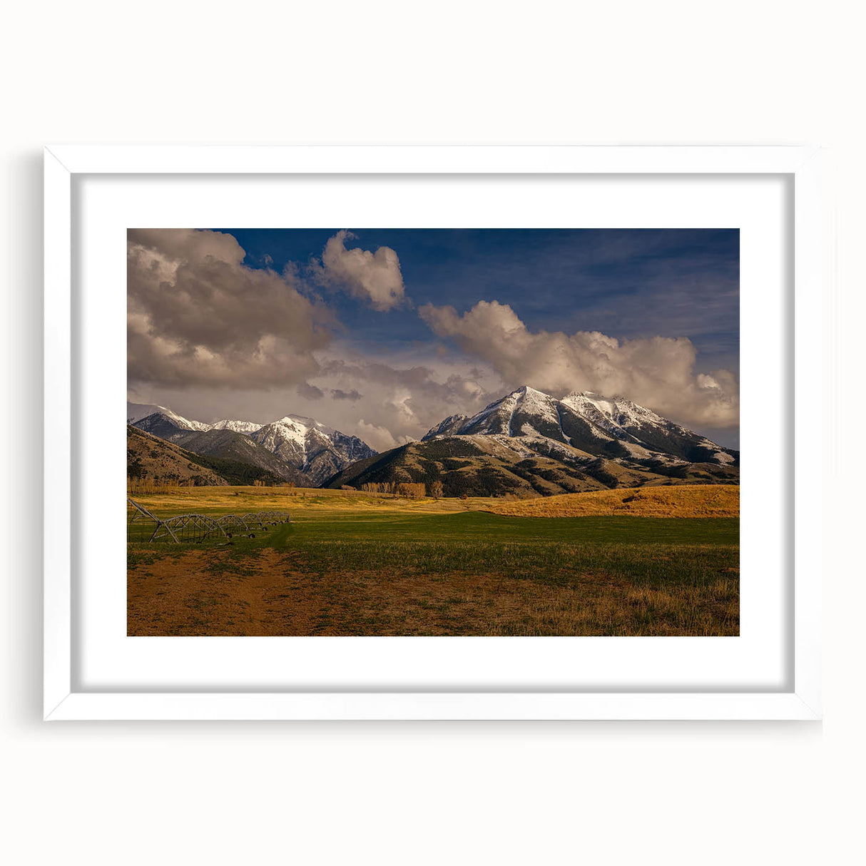Abstract art print depicting a Montana landscape in muted earth tones on a framed white mat, ideal for dining room decor.