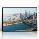 Large abstract wall art of Pittsburgh skyline in muted gray and blue tones on framed acrylic, ideal for modern office decor.