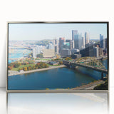Mid-century modernist art depicting the Pittsburgh skyline, rendered in muted gray and blue tones on a framed acrylic print.