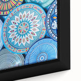 Close-up of a textured black wall art featuring a colorful Moroccan scenery on a framed canvas.