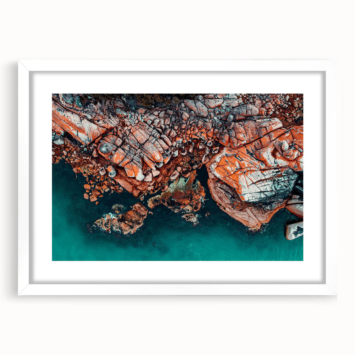 Textured abstract art print of Tasmania scenery in muted earth tones on a framed white mat, suitable for bedroom decor.