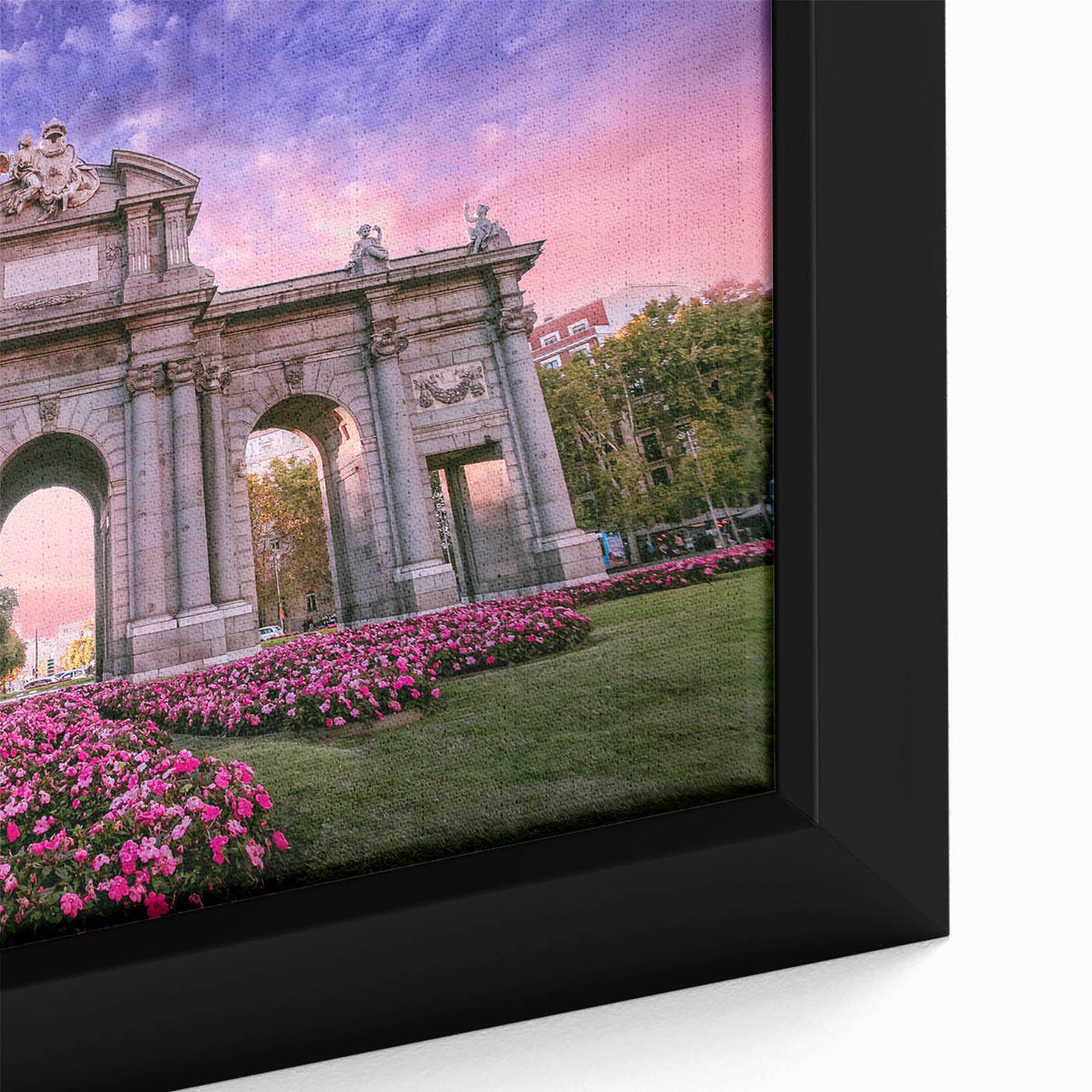 Close-up of a framed canvas featuring a textured, colorful depiction of Madrid’s skyline on a black background.