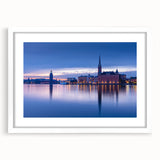 Abstract art print of Stockholm's cityscape in muted gray and blue tones, framed with a white mat.
