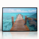 Large abstract wall art depicting Cancun scenery in muted blue and green tones, framed in black acrylic.