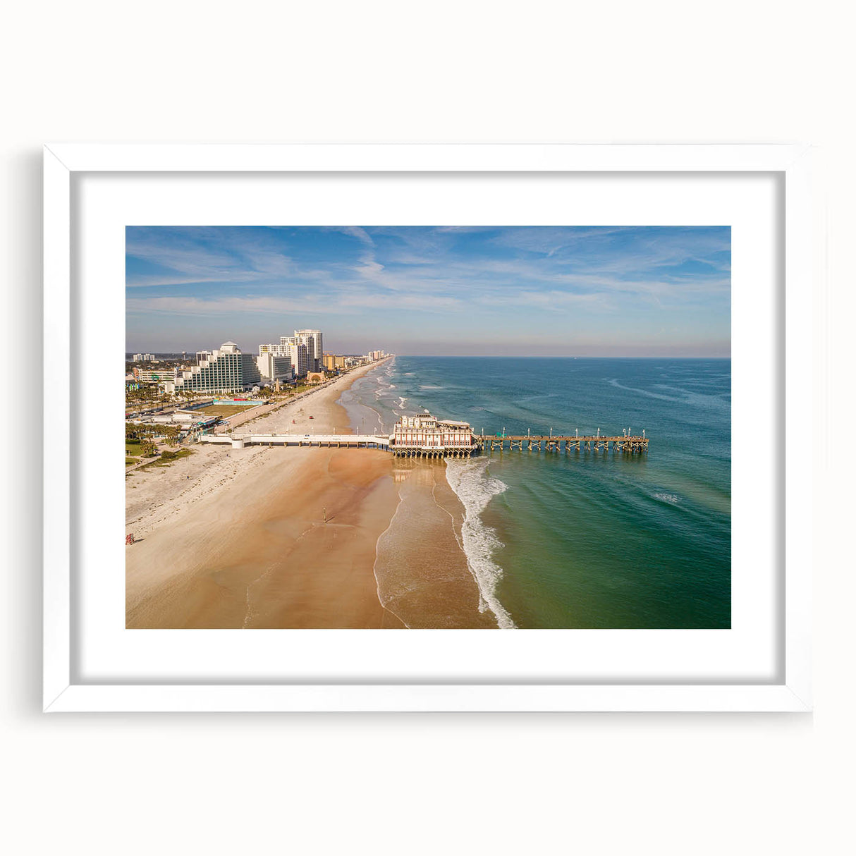 Abstract art print of Daytona scenery in muted blue and green, framed with a white mat, ideal for dining room decor.