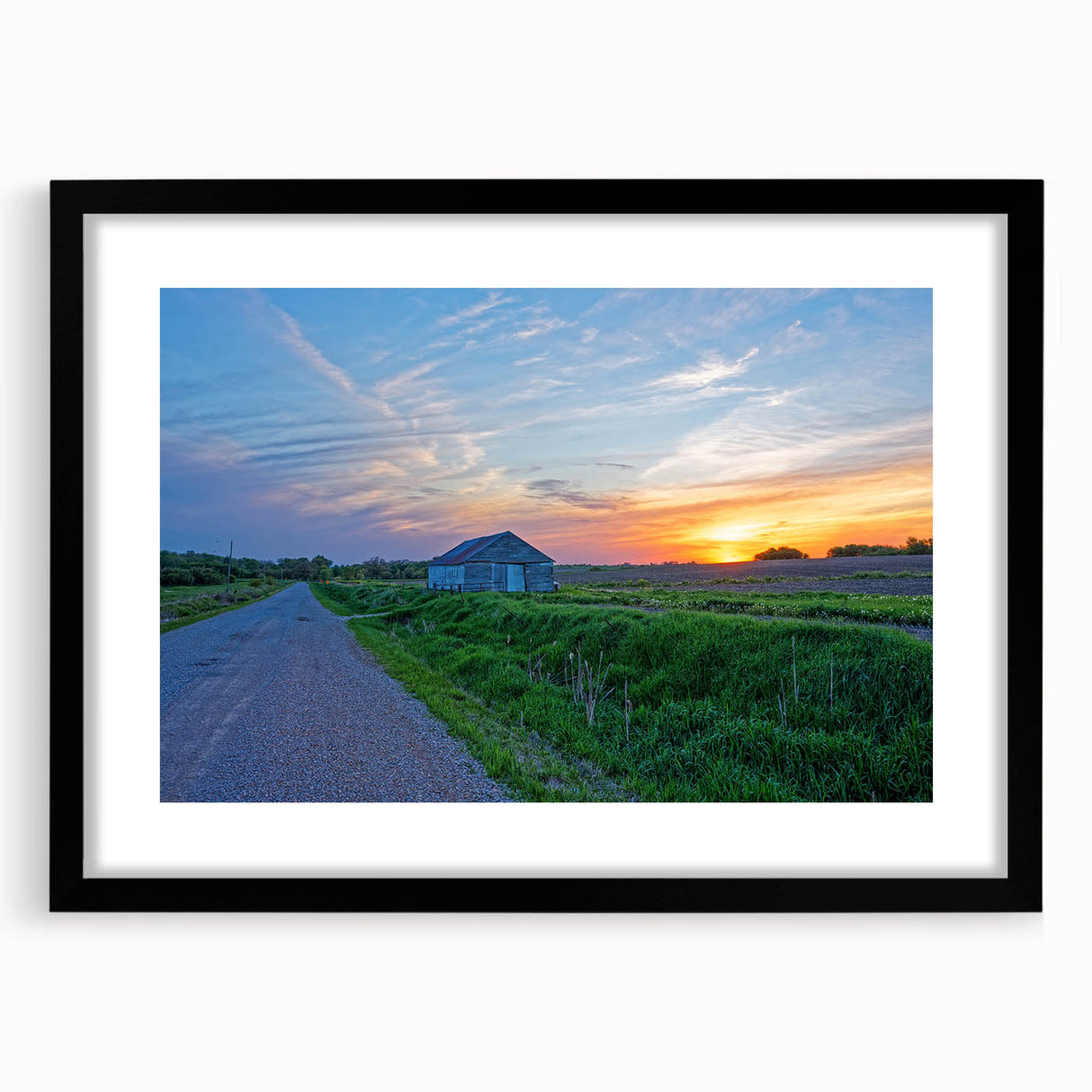 Extra large abstract art print of colorful, textured Iowa scenery on a black framed canvas, ideal for living room decor.