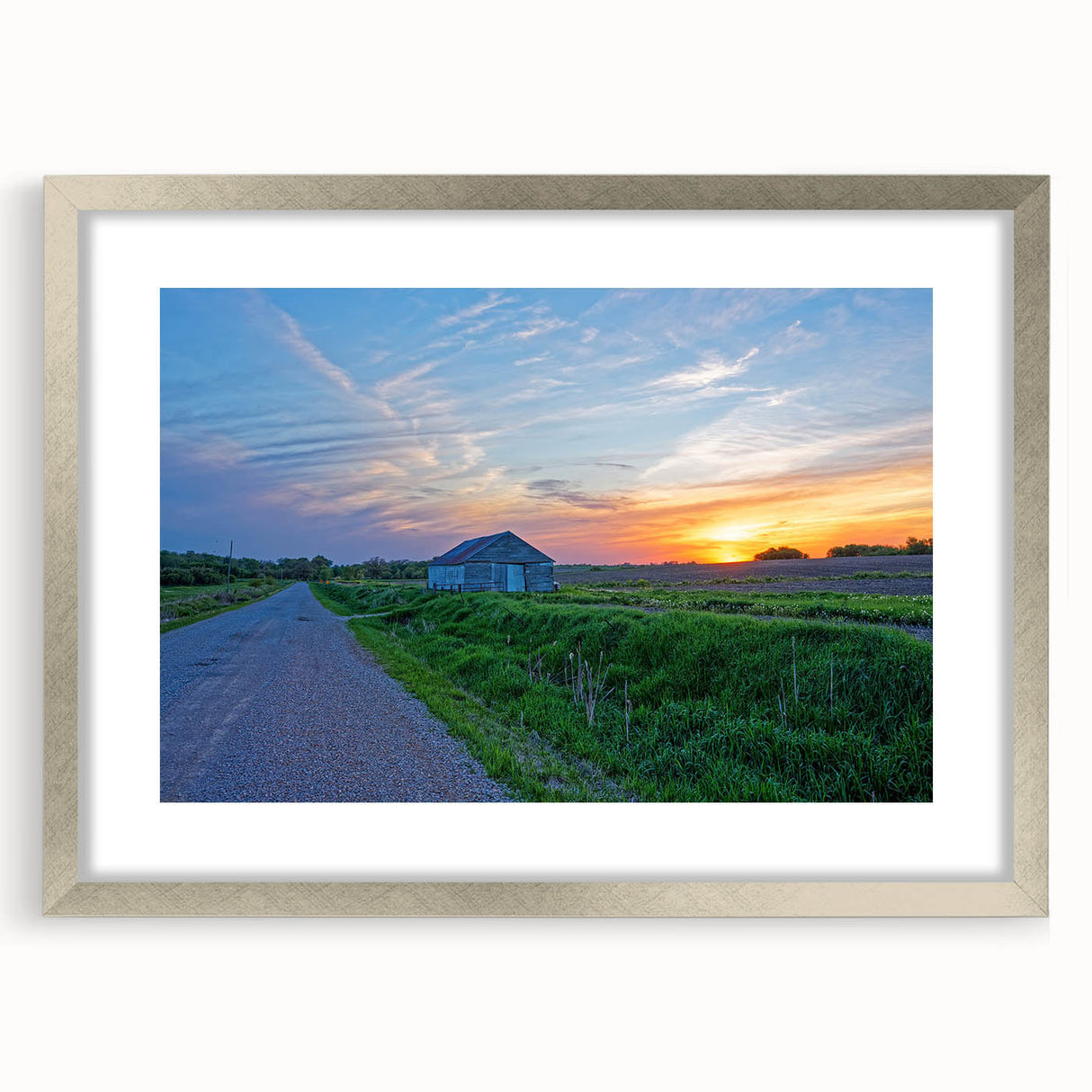 Textured abstract art print depicting Iowa scenery in muted earth tones, framed in silver, ideal for bedroom art.