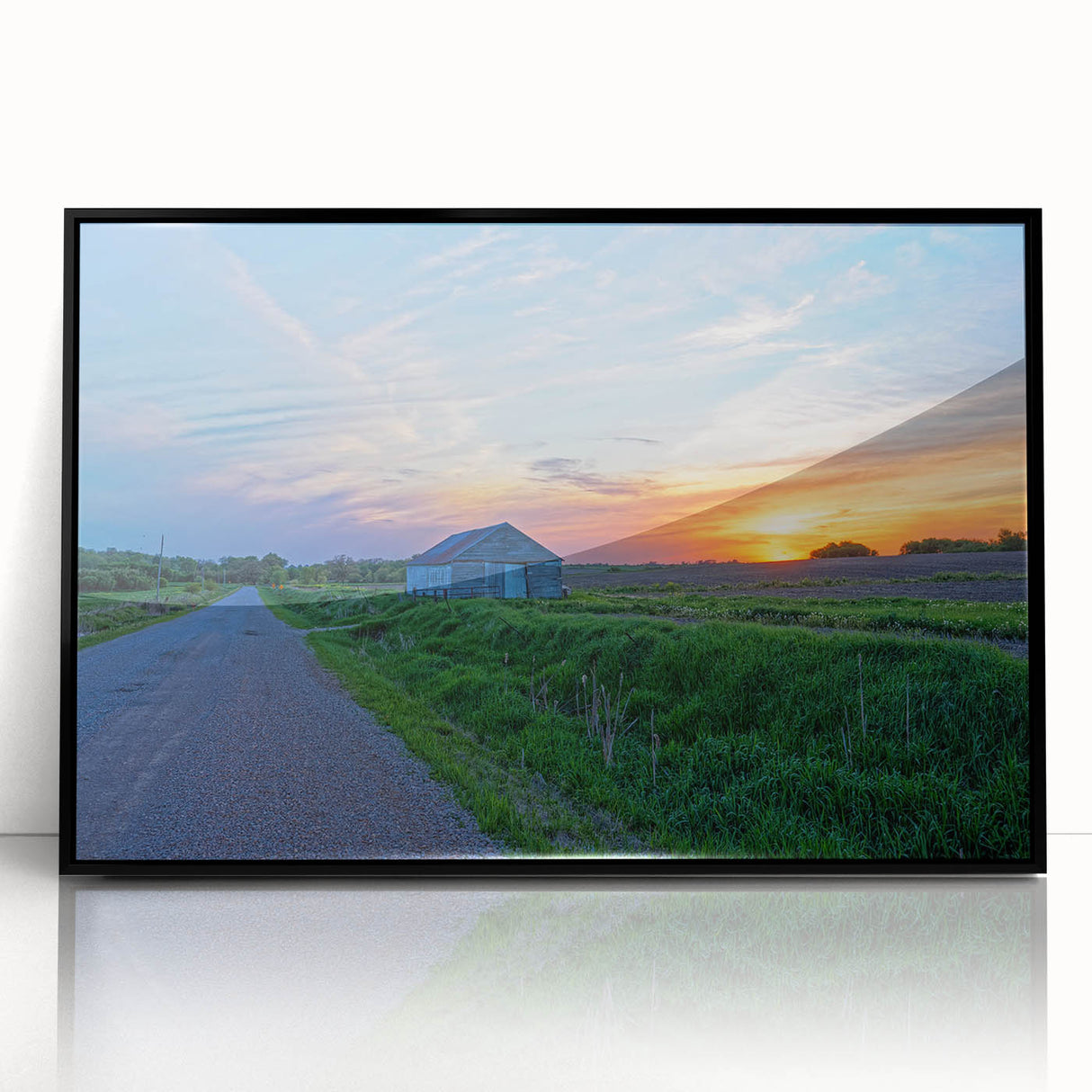 Large abstract wall art depicting a stylized Iowa landscape in muted earth tones, presented in a black framed acrylic print.