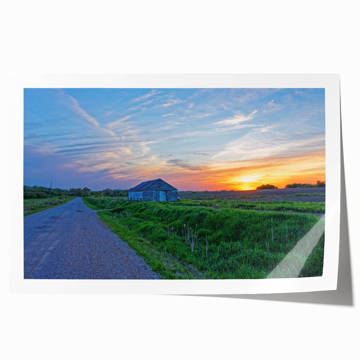 Rolled print of a serene Iowa landscape with soft green fields under a clear blue sky, ideal for dining room wall art.