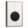 Framed minimalist wall art featuring an abstract design in black, displayed from a side view against a neutral background, ideal for modern decor.