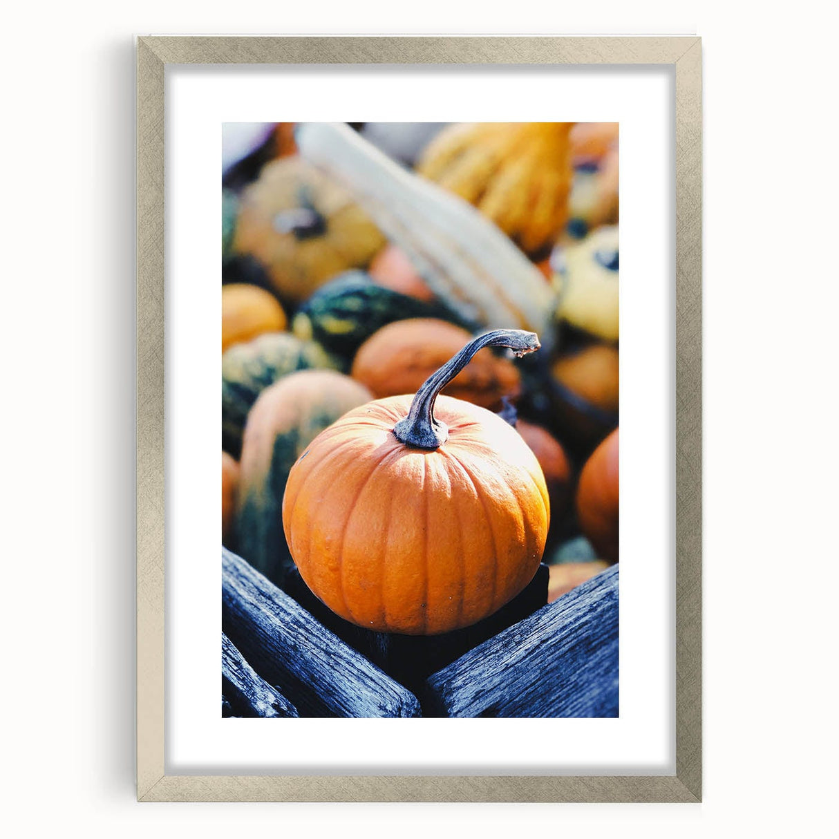 Textured abstract art print in orange and brown tones, framed in silver, ideal for bedroom art.