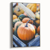 Framed canvas depicting a vintage landscape art painting of autumn trees in vibrant orange and red tones.