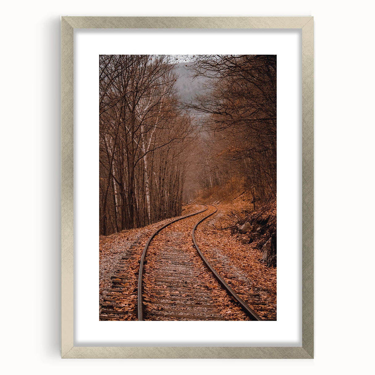 Textured abstract art print depicting autumnal hues in a silver frame, suitable for bedroom decor.