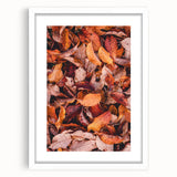 Abstract art print featuring swirling autumnal hues on a white framed canvas, suitable for dining room or bedroom decor.