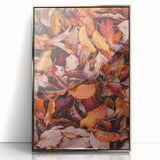Mid-century modernist art depicting an abstract fall scene in orange and brown tones, framed in silver acrylic.