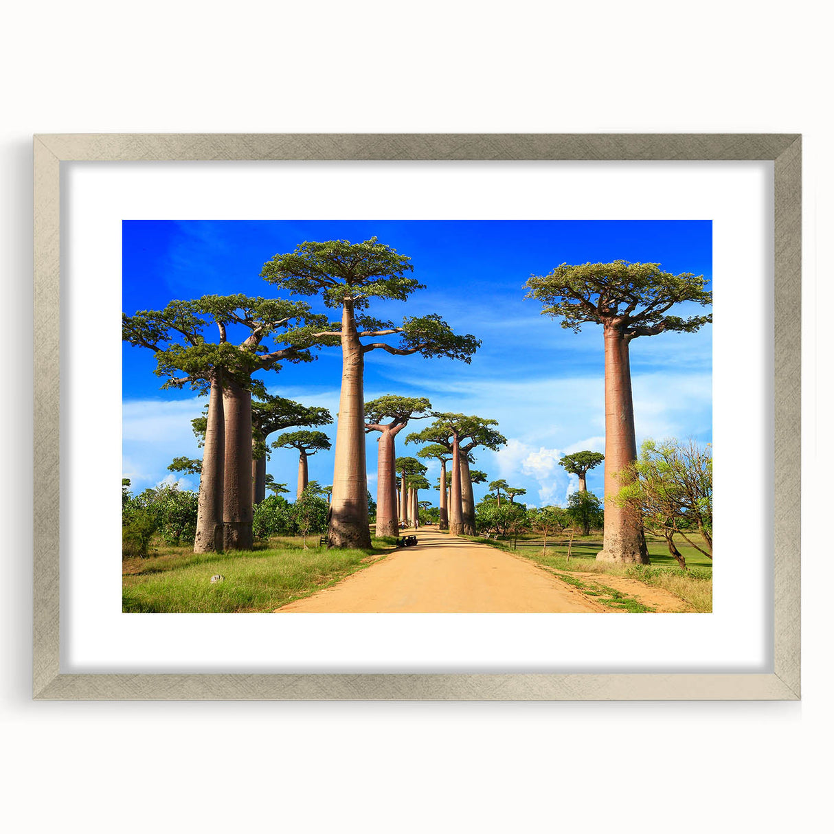Abstract art print of Madagascar scenery in muted earth tones on a framed silver mat, ideal for dining room decor.