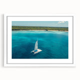 Textured art print of an abstract Caribbean scene in muted blue and green tones on a framed white mat.