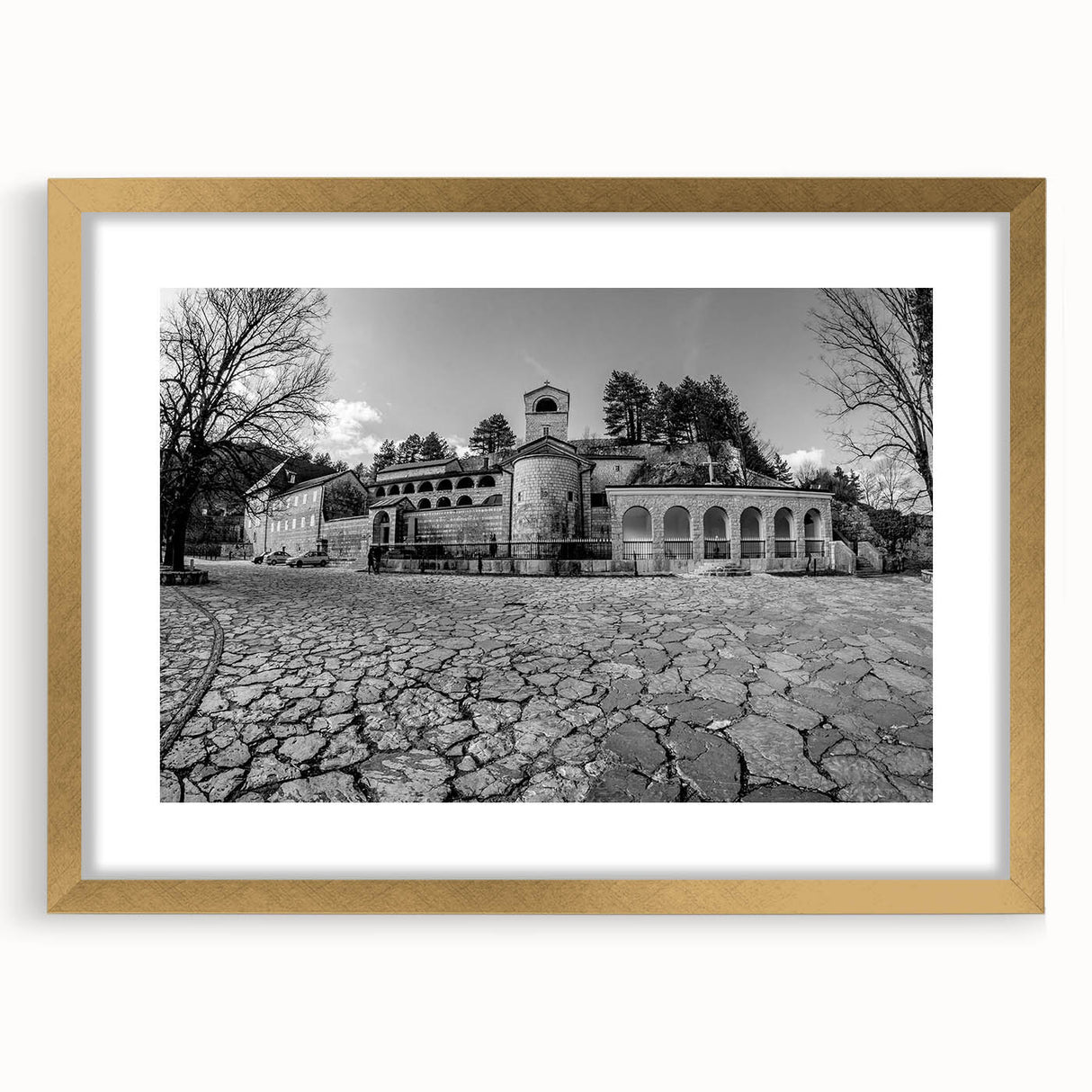Abstract art print of Montenegro scenery in muted earth tones, framed in gold, suitable for bedroom or dining room decor.