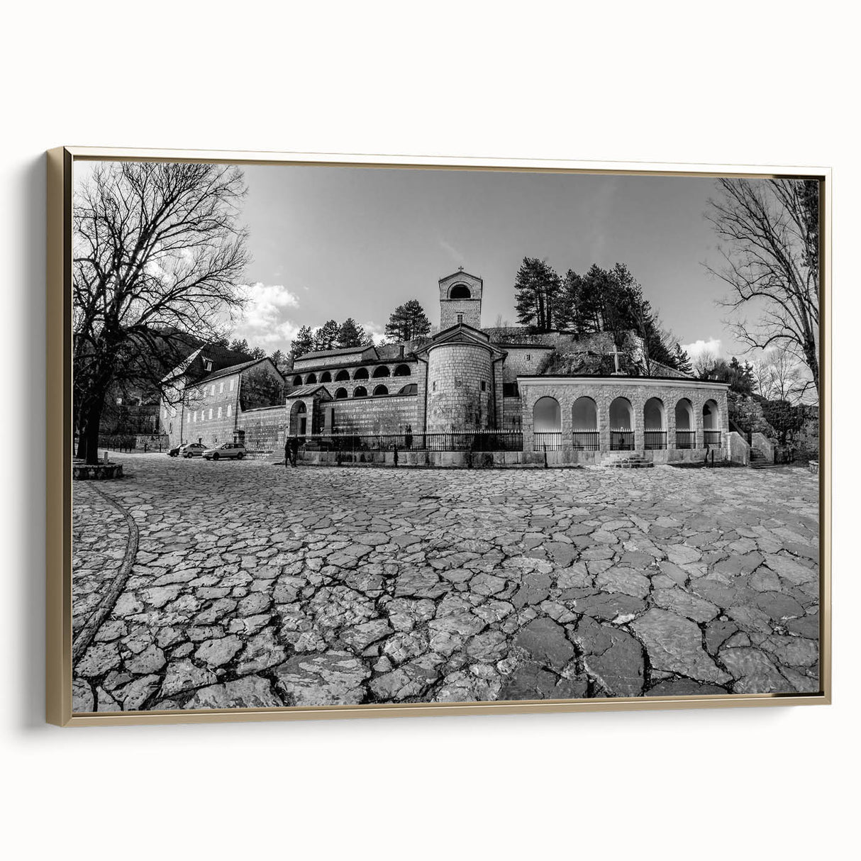 Framed canvas of a vintage-style landscape painting depicting the Montenegro scenery, in muted gold and black tones.