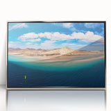 Large art print of a Canary Islands landscape in muted earth tones on a silver-framed acrylic.
