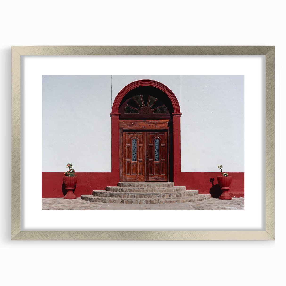 Textured abstract art print depicting Baja California scenery in earthy tones on a silver-framed mat.