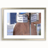 Textured art print of abstract Tel Aviv skyline in muted earth tones on a framed silver mat, suitable for bedroom decor.