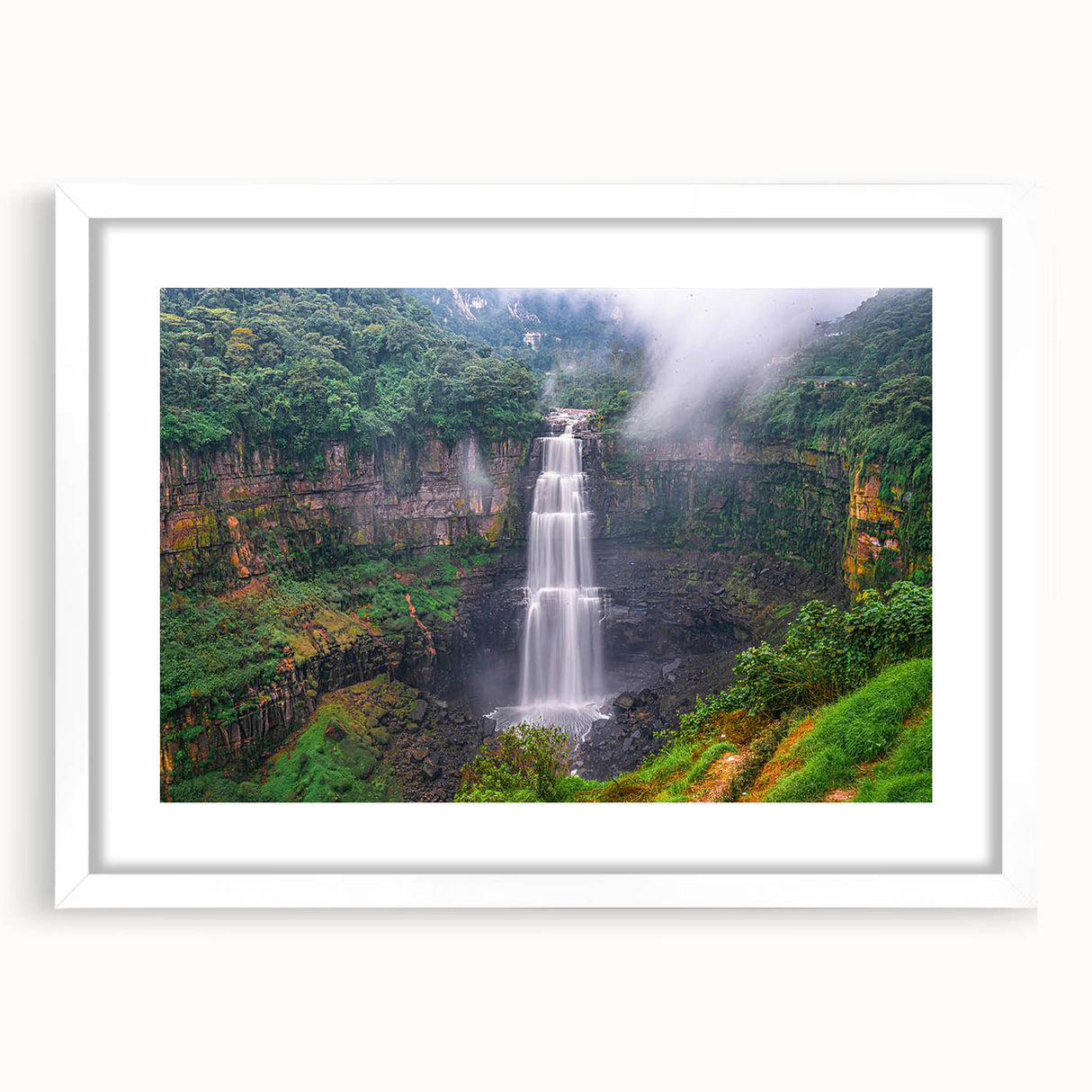 Abstract art print of a stylized Colombian landscape in vibrant earth tones on a framed white mat.