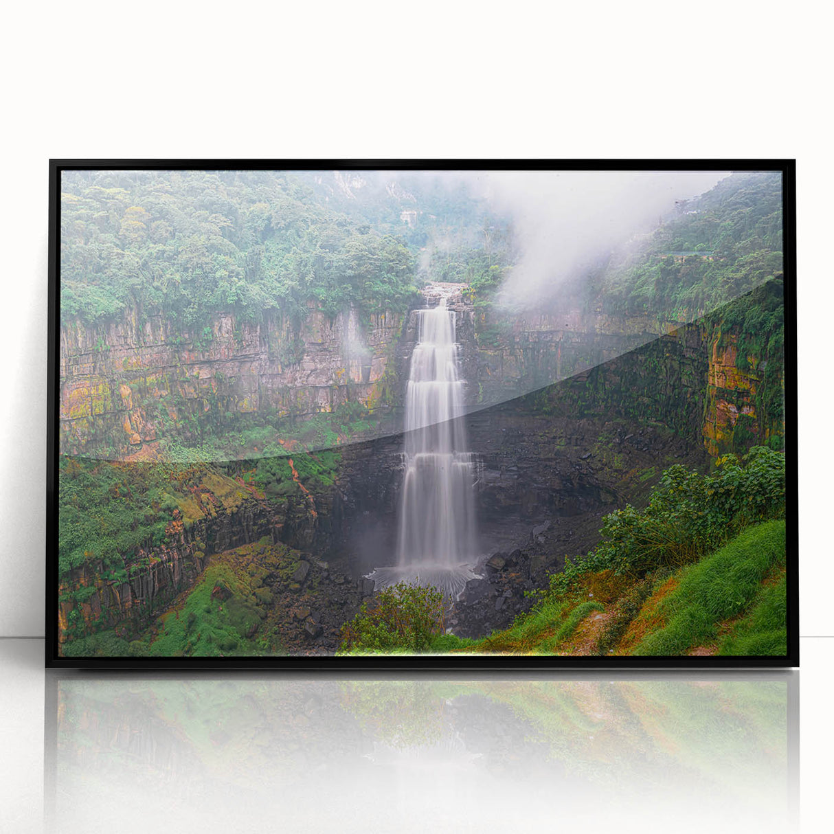 Large abstract wall art featuring a stylized Colombian landscape in vibrant blues and greens, framed in black acrylic.