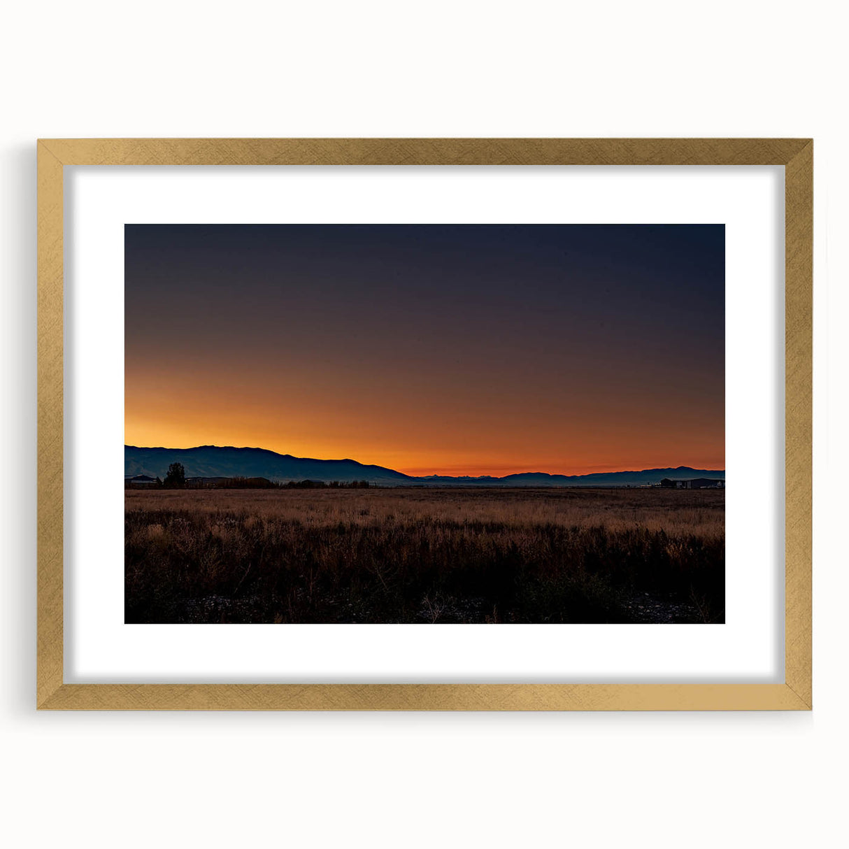 Extra large abstract art print featuring textured scenery of Montana in muted earth tones, framed in gold.