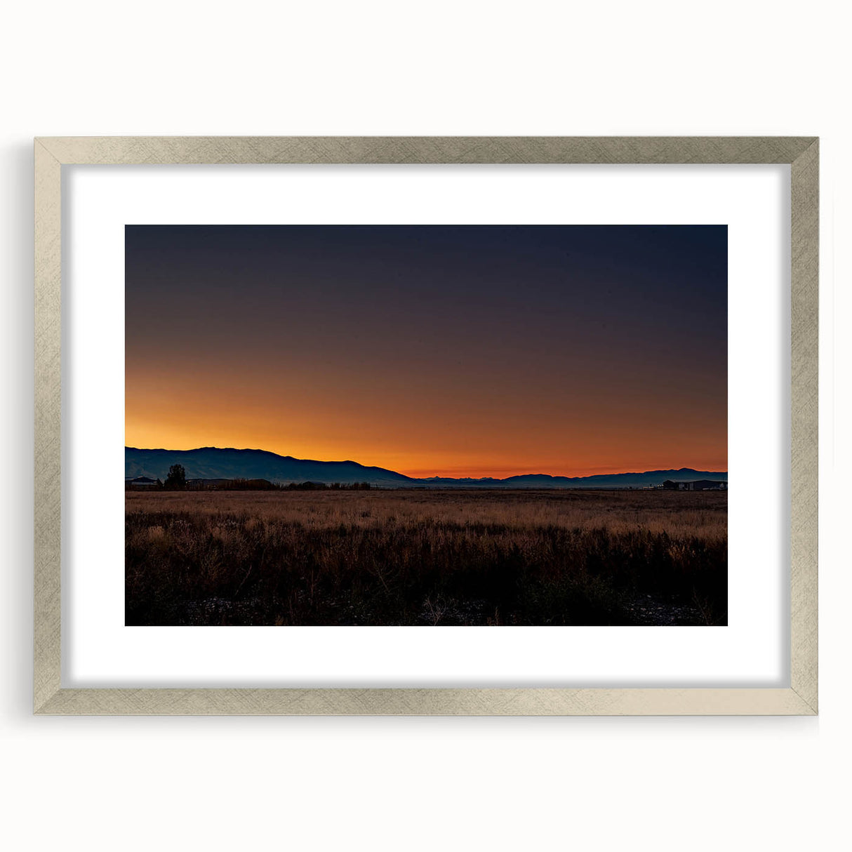 Textured abstract art print of Montana scenery in muted earth tones on a silver-framed mat, ideal for bedroom art.