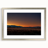 Textured abstract art print of Montana scenery in muted earth tones on a silver-framed mat, ideal for bedroom art.