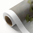 Abstract floral design on rolled canvas featuring vibrant colors and intricate patterns, packaged securely in a cardboard tube for safe delivery and display.