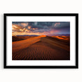 Framed landscape artwork depicting serene sand dunes in a black frame with a mat, showcasing earthy tones and soft textures, ideal for modern home decor.