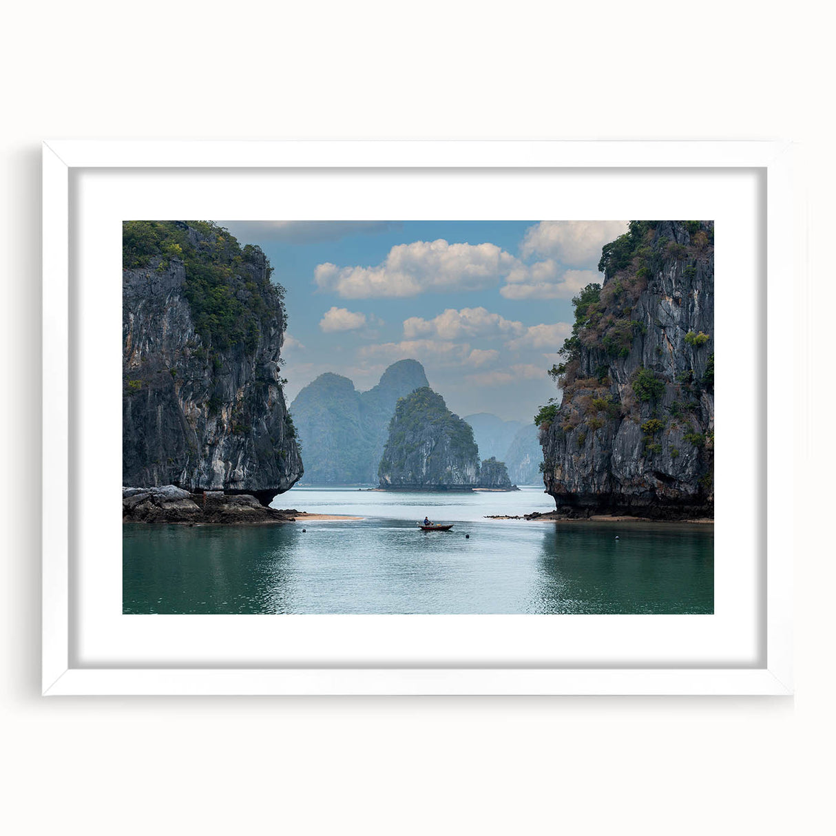 Abstract art print of a Vietnamese landscape in muted greens and blues on a framed white canvas.