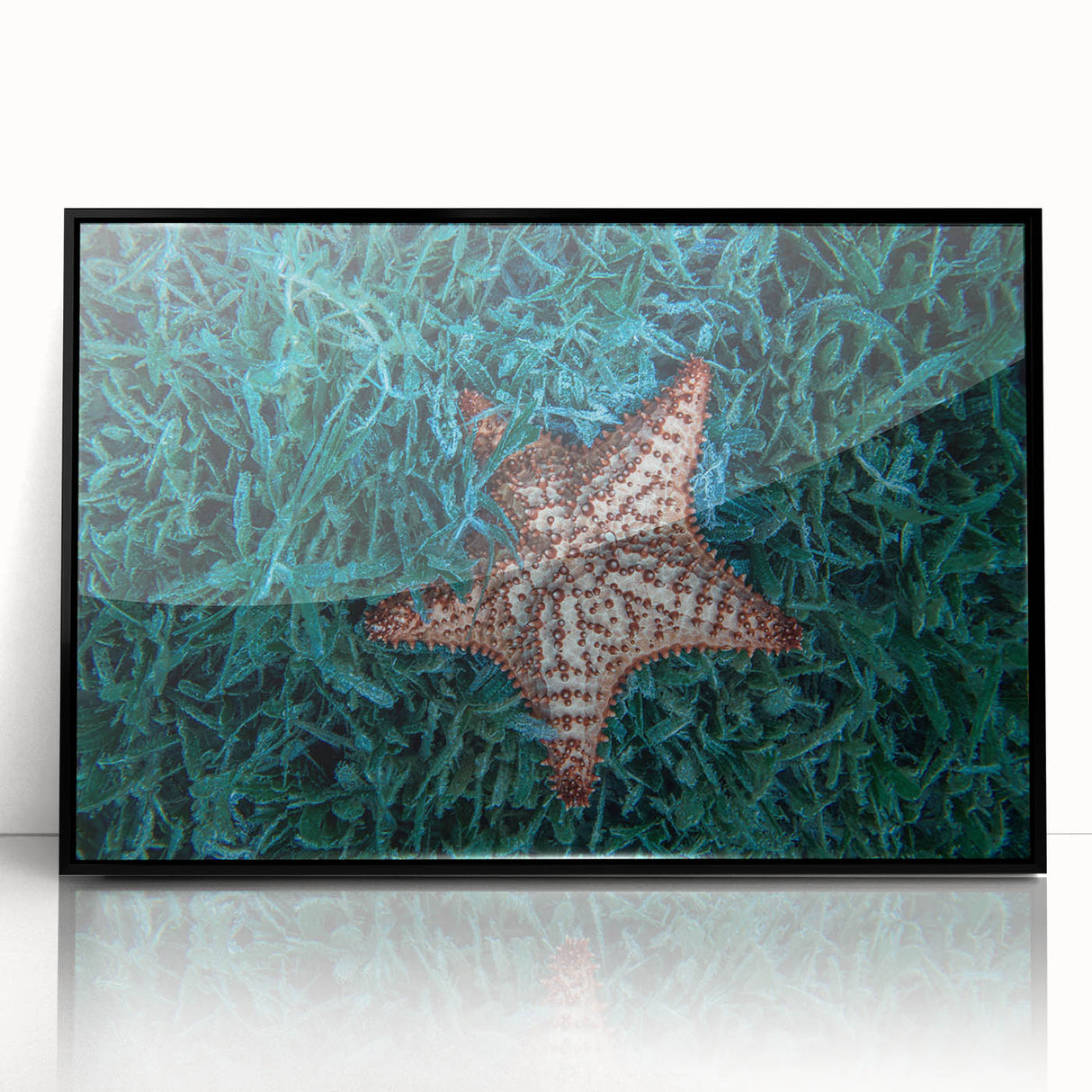 Large abstract wall art depicting a Caribbean scenery in vibrant blue and green, framed in black acrylic.