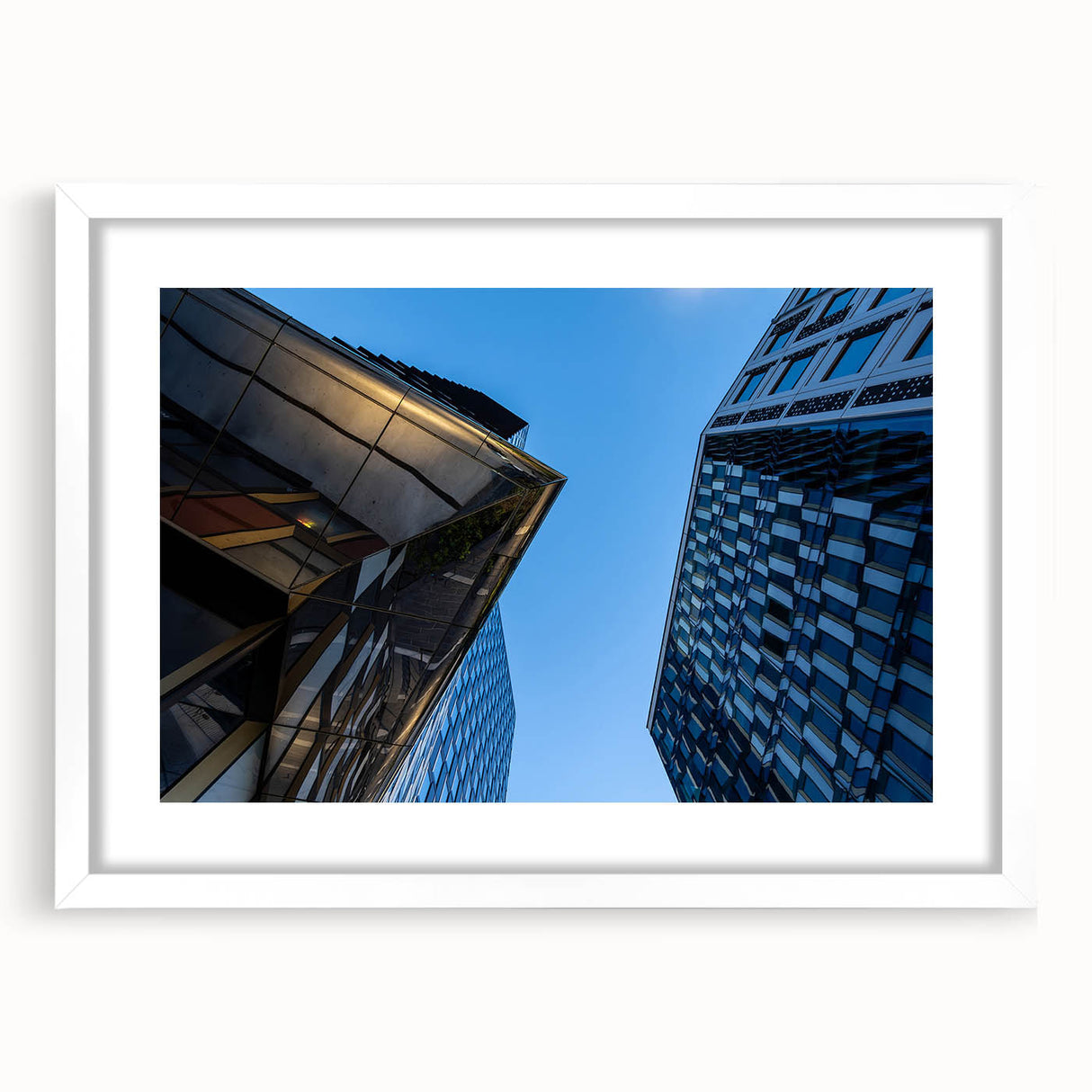 Abstract art print depicting a serene Stockholm landscape in muted blue and gray tones on a framed white mat.