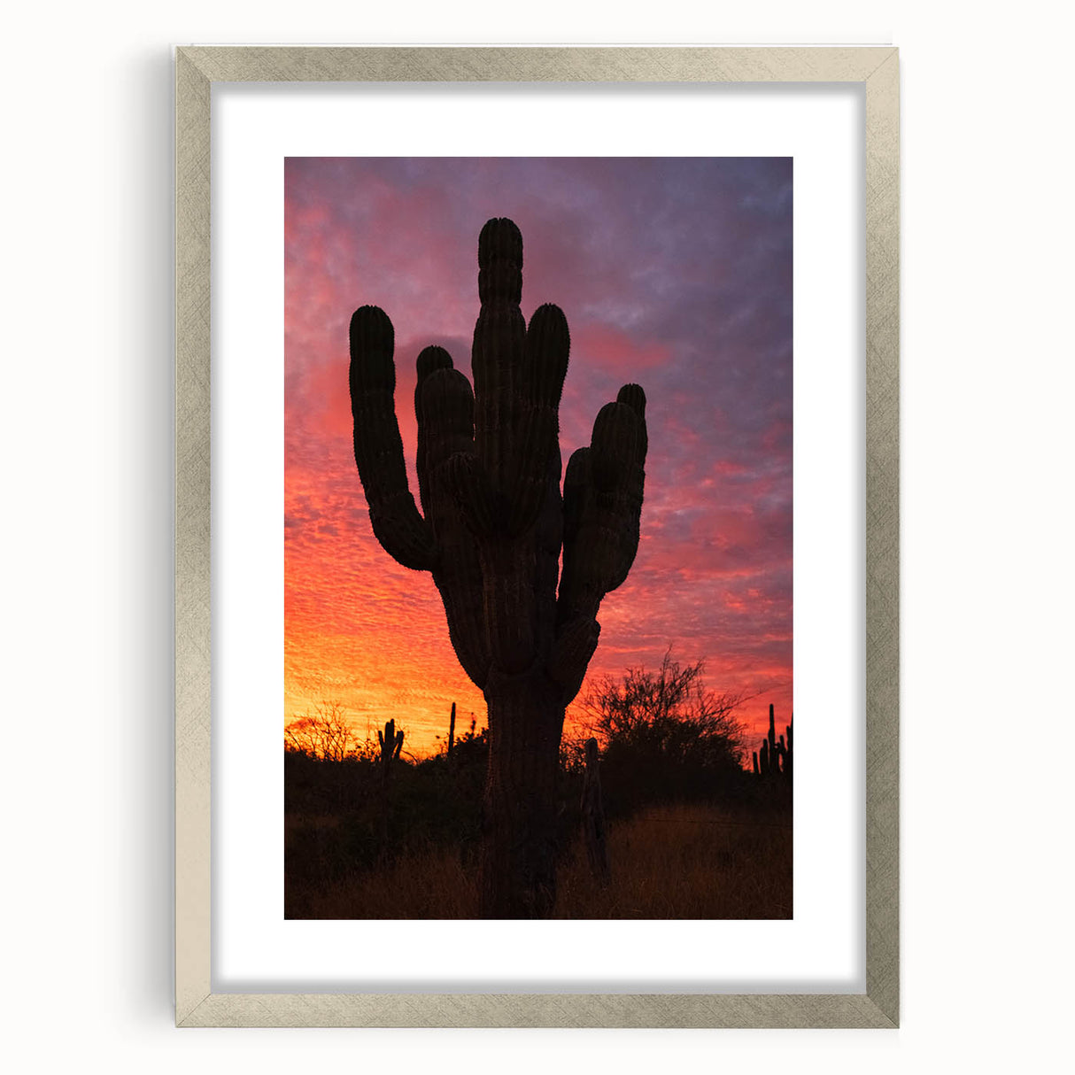 Textured abstract art print of Baja California scenery in muted earth tones, framed in silver, ideal for bedroom decor.