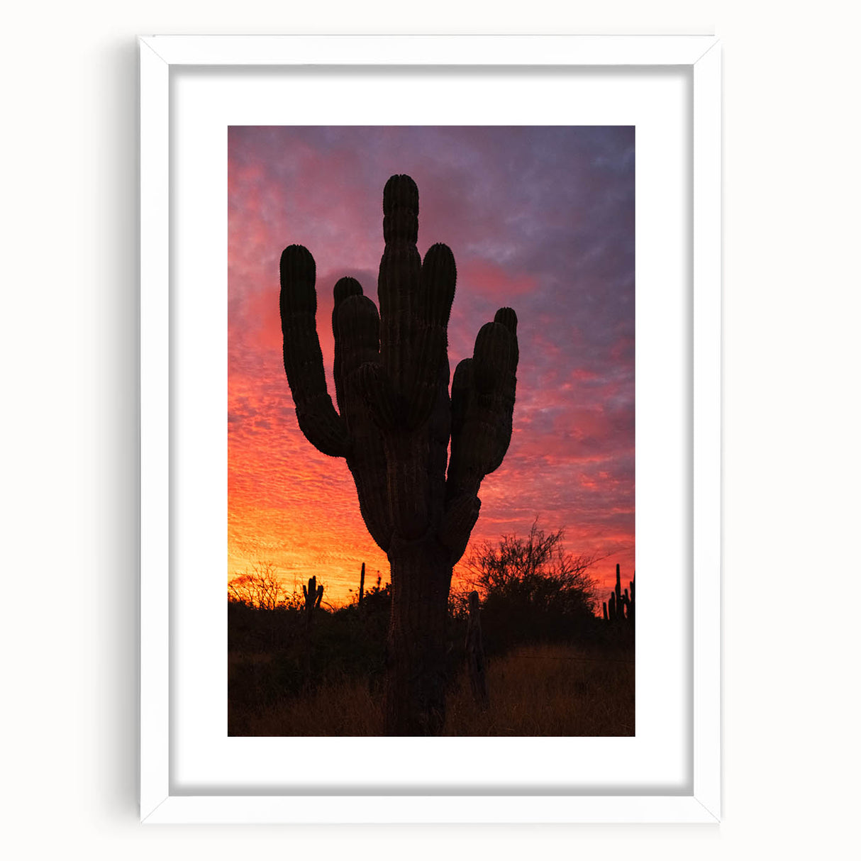 Abstract art print of Baja California scenery in muted earth tones on a framed white mat, suitable for dining room decor.