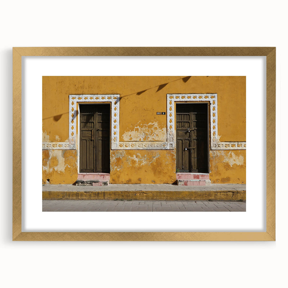 Extra large abstract art print depicting a textured scenery of Quintana Roo in muted earth tones, framed in gold.