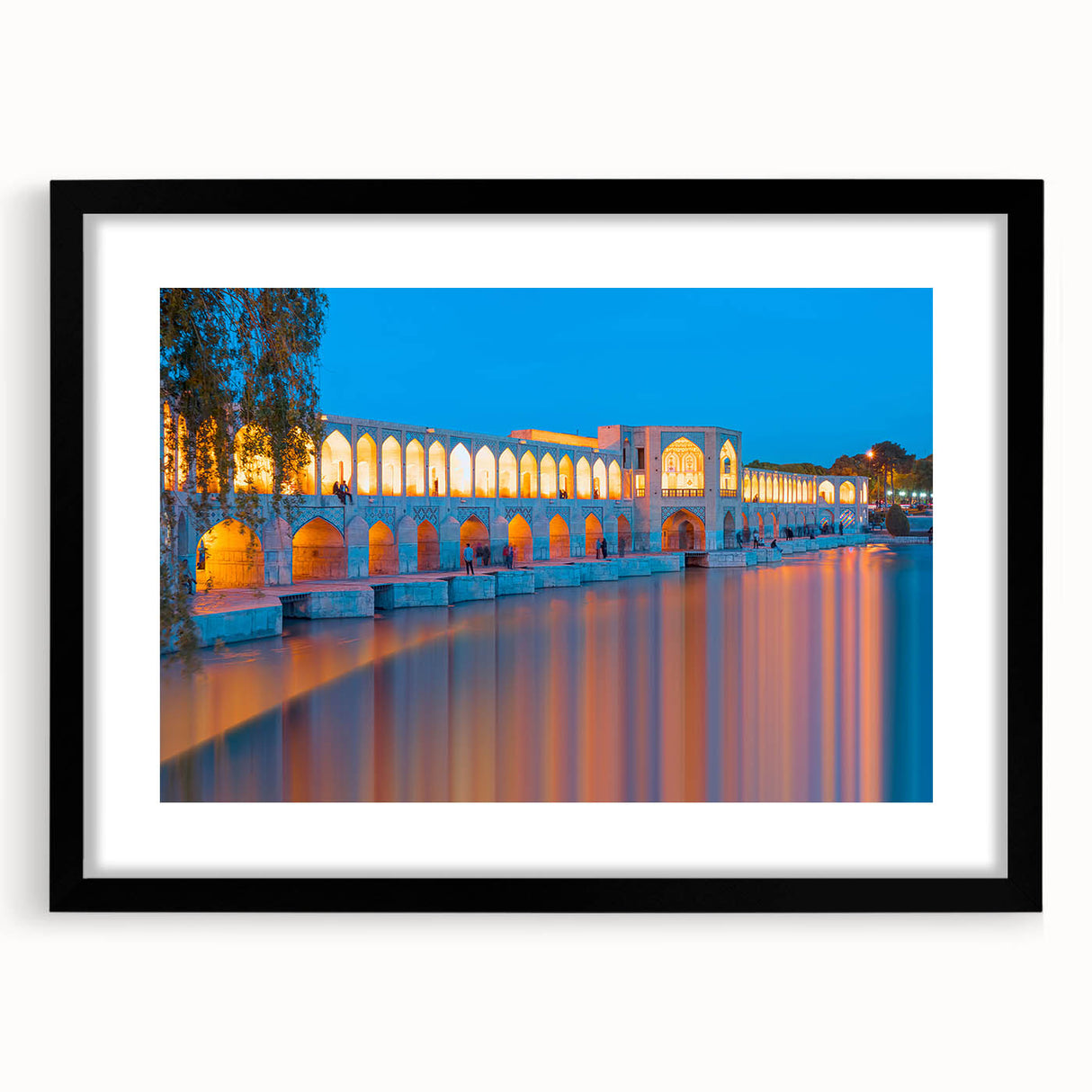 Abstract art print featuring a colorful, textured scenery of a Middle Eastern landscape, in a black frame with mat.