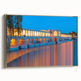 Framed canvas featuring a vintage-style landscape painting of a Middle Eastern scenery in muted gold and black tones.