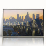 Mid-century modernist art depicting Los Angeles skyline in muted gray and blue tones on a silver-framed acrylic print.
