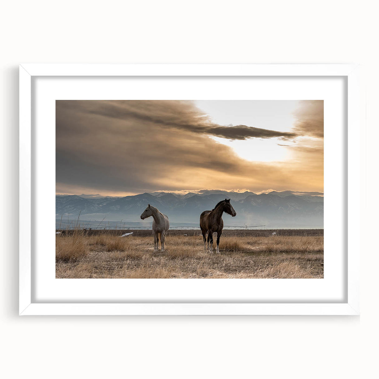Abstract art print of Montana scenery in muted earth tones on a white framed mat, suitable for dining room decor.