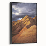 Framed canvas artwork depicting a serene desert landscape with warm hues and intricate textures, showcased from a black side view, ideal for modern home decor.