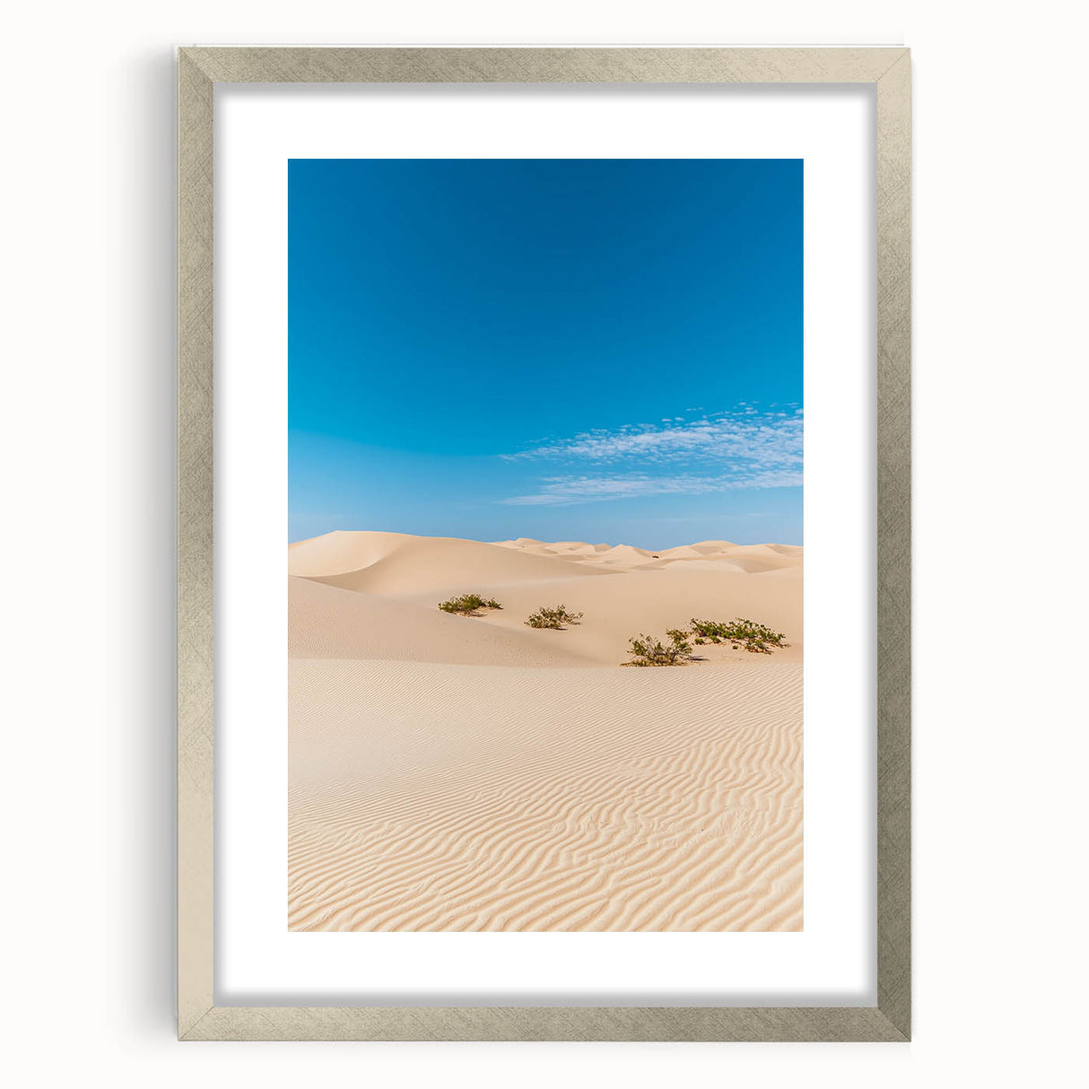 Framed artwork showcasing a serene landscape of sand dunes, elegantly presented with a silver mat. Ideal for enhancing home decor with a touch of nature's beauty.