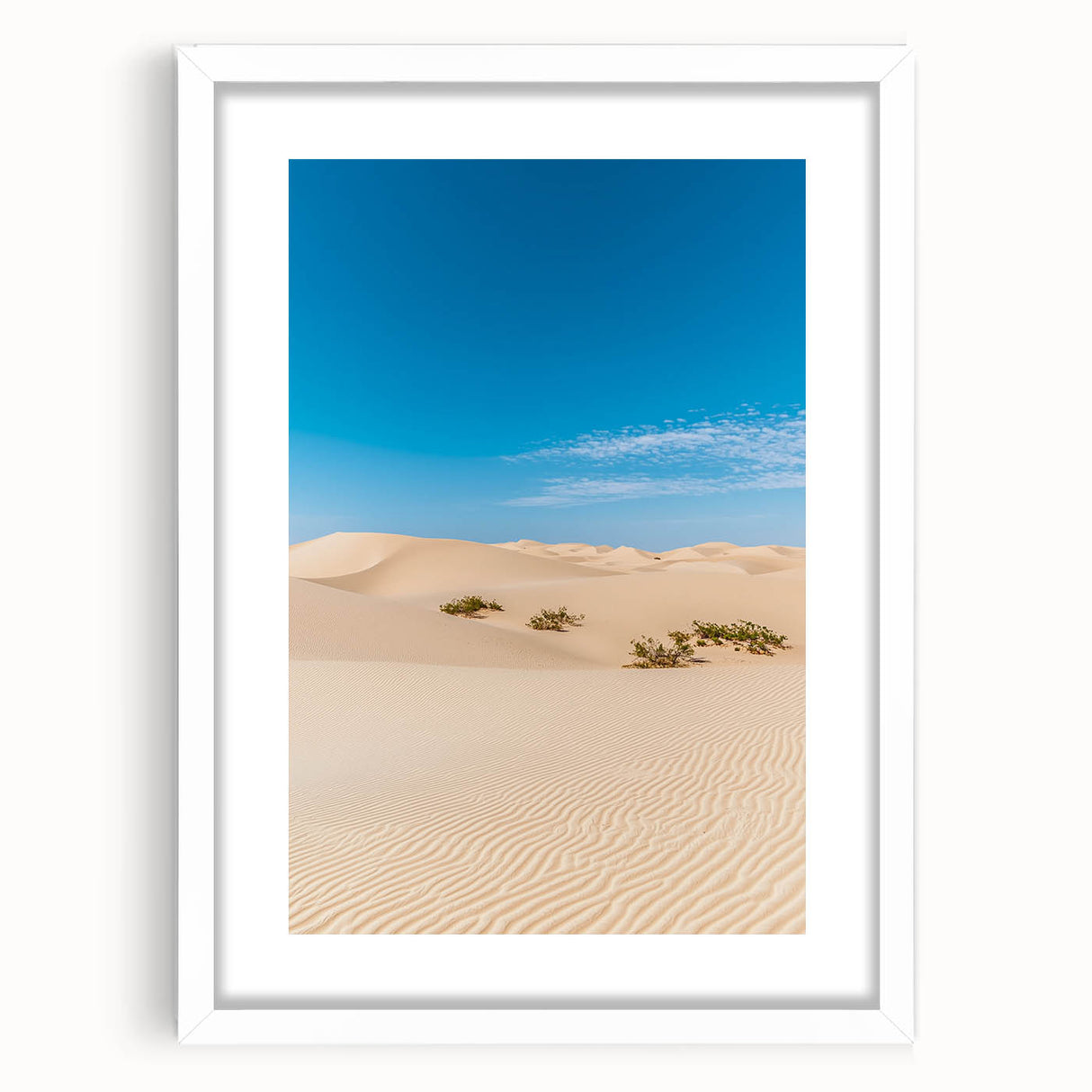 Framed landscape artwork showcasing serene sand dunes in neutral tones, presented with a white mat, ideal for enhancing modern home decor.