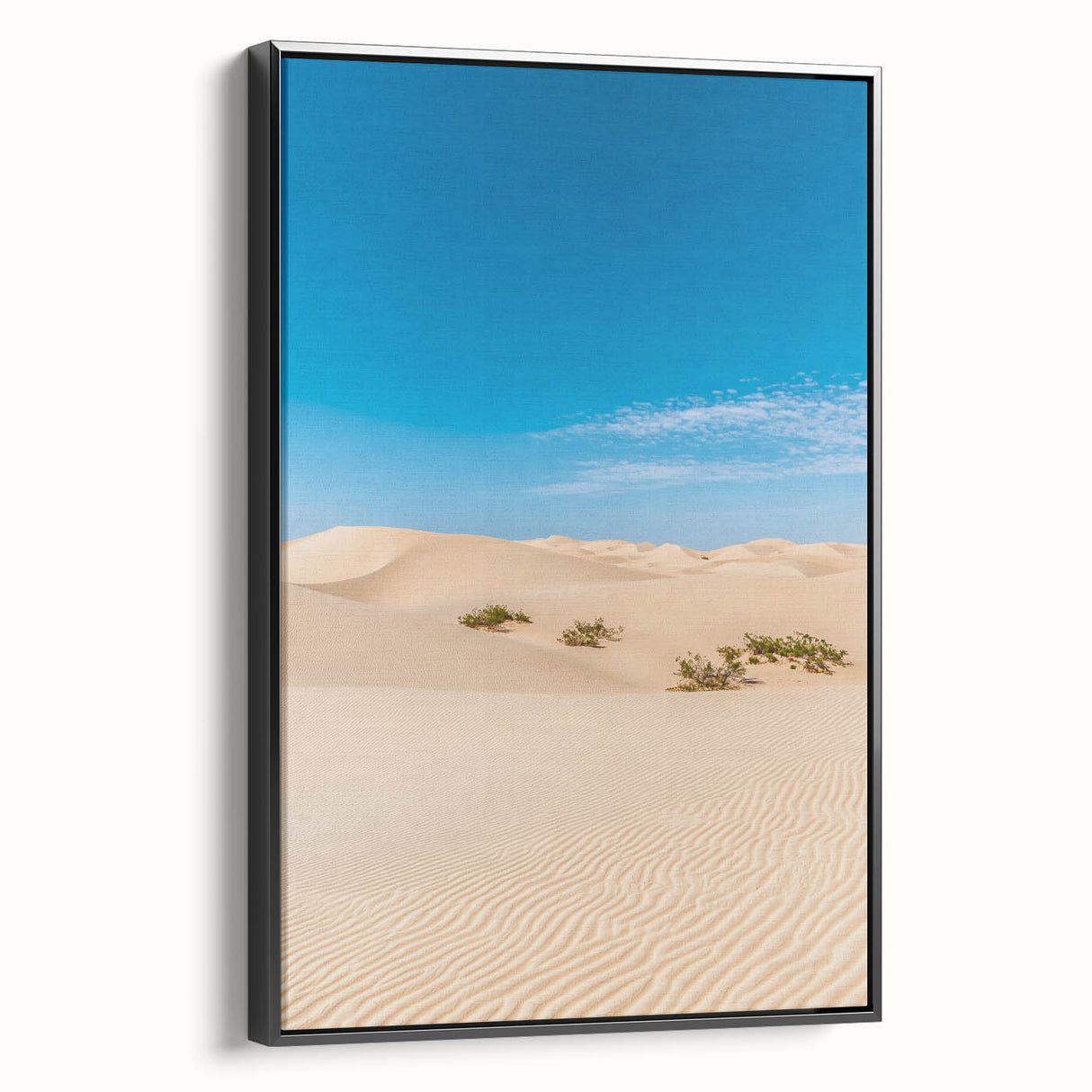 Framed canvas art depicting serene desert dunes in warm tones, elegantly set in a sleek black frame, perfect for modern home decor. Ideal for nature enthusiasts.